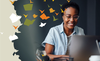 Lady sitting at laptop and smiling